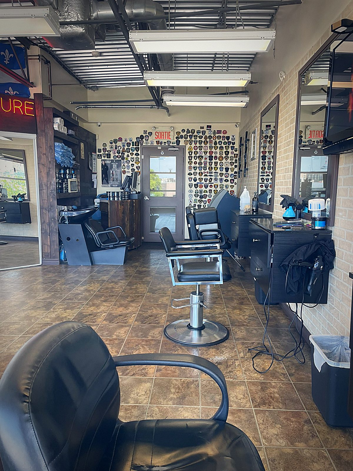 Barber chairs and the patch wall at Coiffure Toni